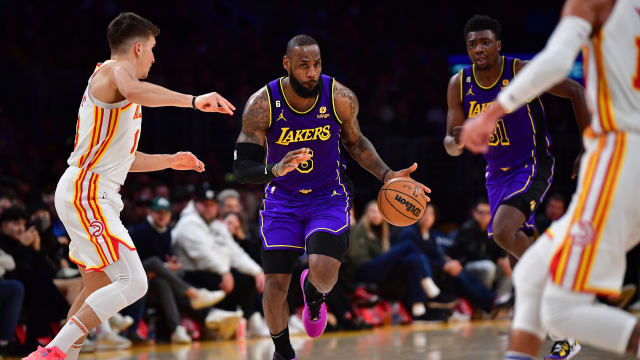 Lakers forward LeBron James dribbles the ball up the court against the Hawks.